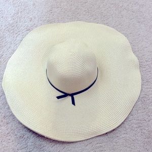 Wide brim fancy beach hat. Black bow detail. Elastic chin strap